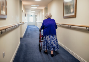 Older woman walking down a hall